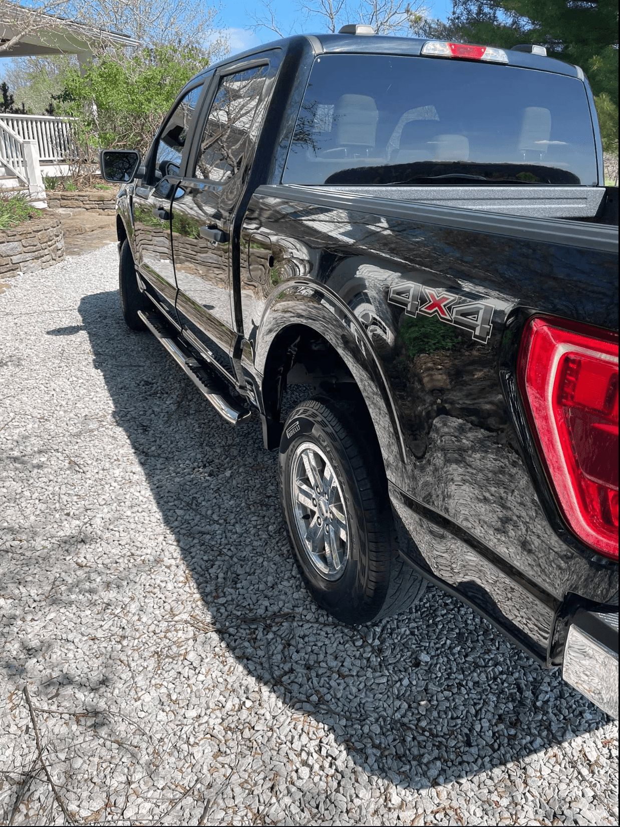 Black Ford F-150 4x4 side profile, detailed and reflective after a mobile exterior detail